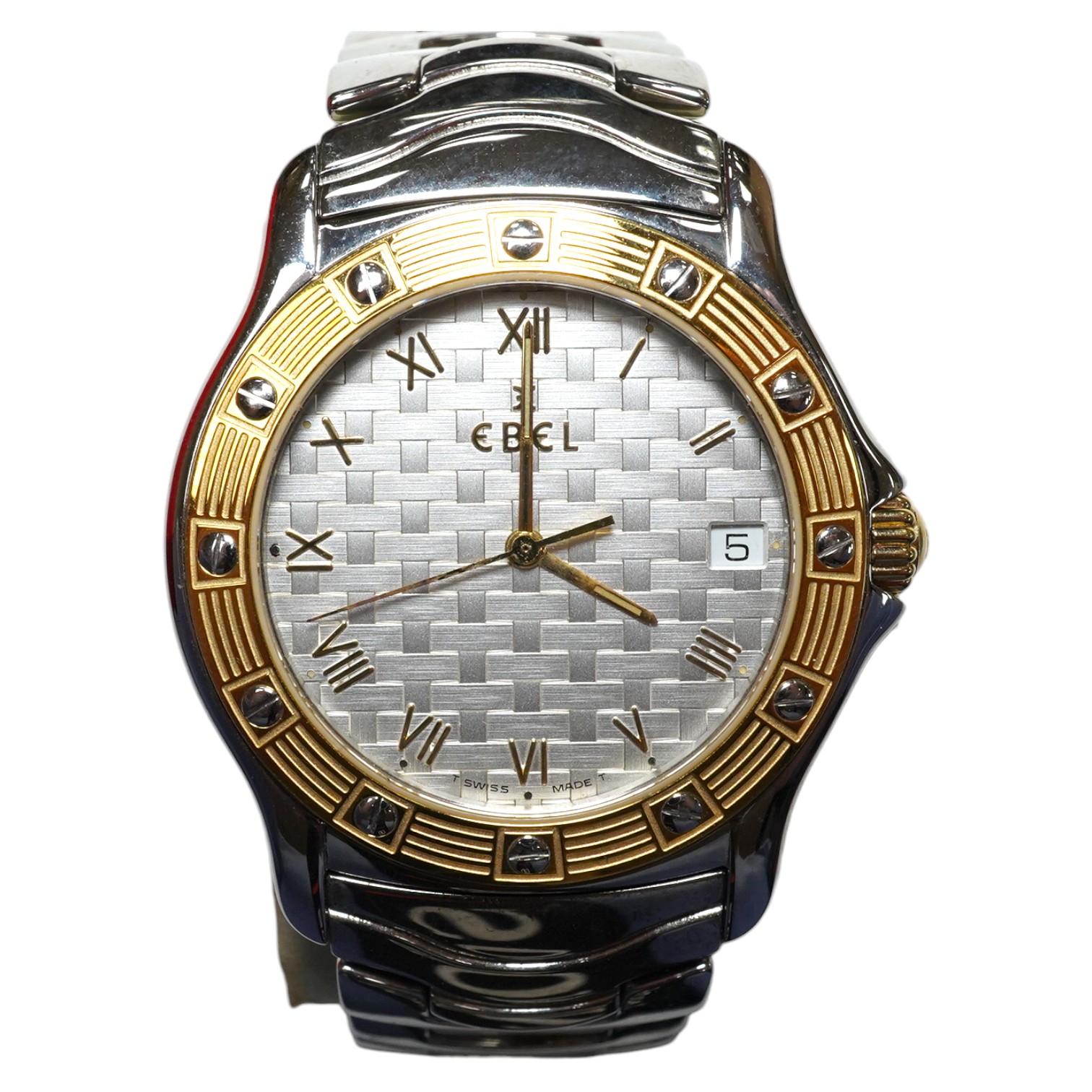 A gentleman's modern steel and gold plated Ebel Wave quartz wrist watch, with basket weave dial, on a stainless steel Ebel bracelet, with box. Condition - fair